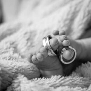 Wedding rings on a newborn babies toes